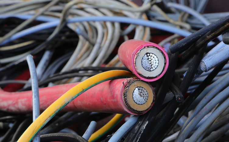 electric cables of copper or aluminum discarded and separately collected in recycling center for the reuse of recyclable materials heat resistant electrical tape is an important part of wire insulation, shown here.